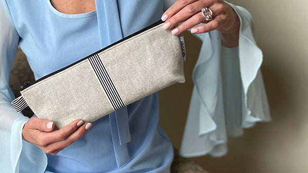 model holding a 12 inch denim zipper pouch for personal massager